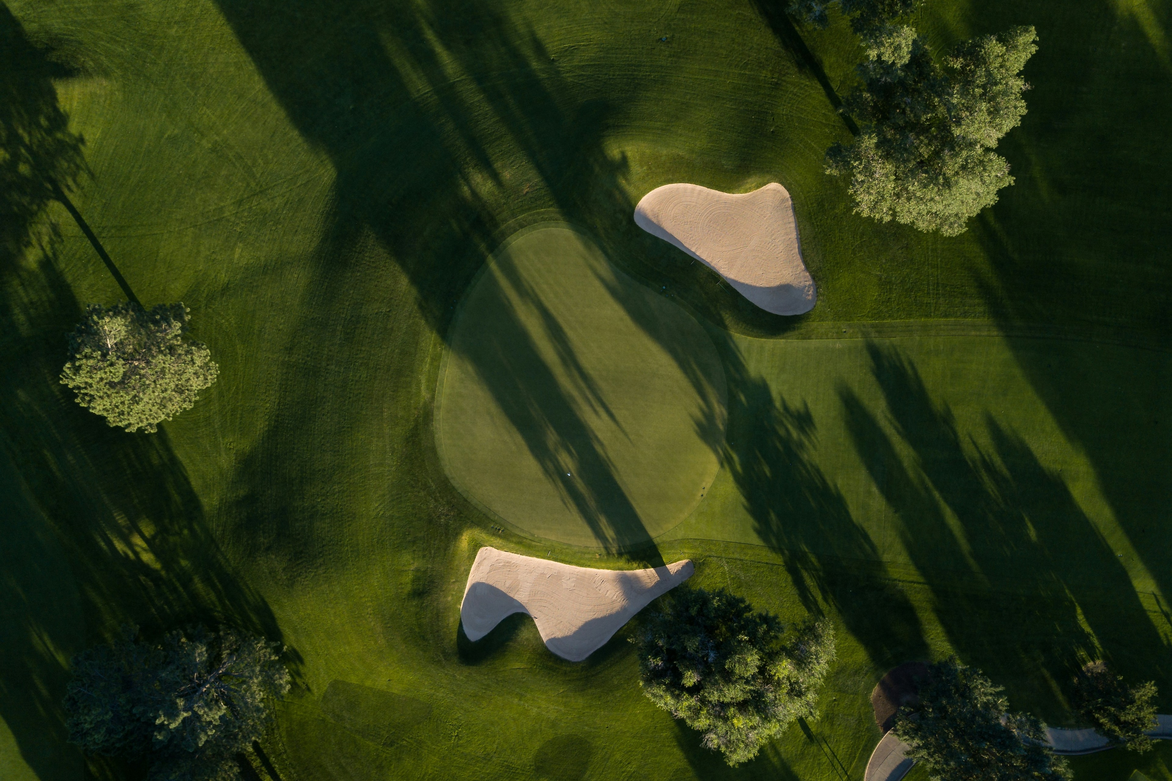 Aerial view of a golf green and bunkers